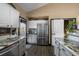 Stainless steel appliances, dark wood floors, and marbled countertop kitchen at 2321 Ance St, Strasburg, CO 80136