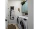 Functional laundry room with washer, dryer, and stylish storage at 2321 Ance St, Strasburg, CO 80136