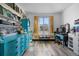 Bright office space with stylish blue cabinetry, desk, and natural light at 2321 Ance St, Strasburg, CO 80136