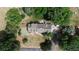 Aerial view of the property showcasing the house, landscaping, pond, and surrounding greenery at 620 State Highway 52, Erie, CO 80516