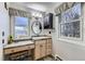 Bathroom featuring a vanity area, a sink, wall lighting, and bright windows at 620 State Highway 52, Erie, CO 80516