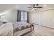 Well-lit bedroom boasts hardwood floors, a ceiling fan, and ample closet space at 620 State Highway 52, Erie, CO 80516