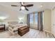 Cozy bedroom with wood floors, ceiling fan, chest and two windows providing natural light at 620 State Highway 52, Erie, CO 80516
