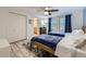 Bright bedroom features two beds, wood floors, a ceiling fan, and an ensuite bathroom at 620 State Highway 52, Erie, CO 80516
