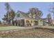 Charming home with a well-maintained lawn, red shutters, and a inviting front porch at 620 State Highway 52, Erie, CO 80516