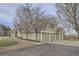 Two-story home with an attached three-car garage, mature trees, and a well-kept lawn at 620 State Highway 52, Erie, CO 80516