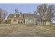 Well-maintained home featuring a covered porch, bay window, and a spacious front lawn at 620 State Highway 52, Erie, CO 80516