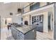 Open concept kitchen with stainless appliances, large center island, and stone fireplace at 620 State Highway 52, Erie, CO 80516