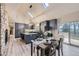 Bright kitchen with stainless appliances, a large center island with seating, and a vaulted ceiling with skylights at 620 State Highway 52, Erie, CO 80516