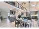 Open concept kitchen with stainless appliances, stone accent wall with a fireplace, and adjacent dining area at 620 State Highway 52, Erie, CO 80516
