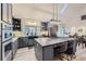 Modern kitchen with stainless steel appliances, a large center island, and stylish pendant lighting at 620 State Highway 52, Erie, CO 80516