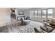 Comfortable living room with large windows, modern decor, and staircase at 620 State Highway 52, Erie, CO 80516