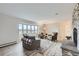 Bright living room featuring a stone fireplace, and lots of natural light from the bay window at 620 State Highway 52, Erie, CO 80516