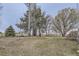 Large yard with mature trees and landscaping, offering plenty of space for outdoor activities at 620 State Highway 52, Erie, CO 80516