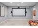 Basement media room provides entertainment space with a large screen, speakers, and cozy carpeting at 3354 Vallejo St, Denver, CO 80211