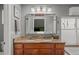 Bathroom with dual sinks, granite counters, and a large mirror at 3354 Vallejo St, Denver, CO 80211