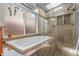 Bathroom with a soaking tub and enclosed glass shower at 3354 Vallejo St, Denver, CO 80211