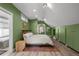 Bedroom with hardwood floors, large bed, tub, and closet storage at 3354 Vallejo St, Denver, CO 80211