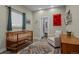 Bedroom featuring wooden crib, accent rug, and attached bathroom at 3354 Vallejo St, Denver, CO 80211