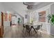 Elegant dining room with modern chandelier, round table, and views of the exposed brick hallway at 3354 Vallejo St, Denver, CO 80211