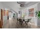 Bright dining area with modern chandelier, hardwood floors, large windows, and a view of the backyard at 3354 Vallejo St, Denver, CO 80211