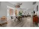 Open-concept dining area with a modern chandelier, dining table, and a view of the comfortable living room at 3354 Vallejo St, Denver, CO 80211
