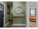 Inviting foyer with stylish decor, a round mirror, and a glimpse into a cozy bedroom at 3354 Vallejo St, Denver, CO 80211