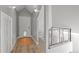 Bright hallway with hardwood floors and staircase at 3354 Vallejo St, Denver, CO 80211