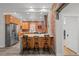 Bright kitchen features stainless appliances, exposed brick, a center island and modern design at 3354 Vallejo St, Denver, CO 80211
