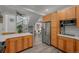 Open-concept kitchen featuring stainless steel appliances and access to the stairwell at 3354 Vallejo St, Denver, CO 80211