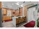Modern kitchen with exposed brick, stainless steel appliances, and a center island with bar seating at 3354 Vallejo St, Denver, CO 80211