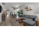Open floor plan featuring living room with sofa, dining area, and access to kitchen, illuminated by stylish chandelier at 3354 Vallejo St, Denver, CO 80211