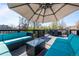 Inviting rooftop deck with cozy seating and an umbrella for shade at 3354 Vallejo St, Denver, CO 80211