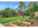 Backyard garden featuring raised garden beds, lush greenery, and a playhouse at 6180 W 77Th Pl, Arvada, CO 80003