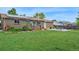 Lush green backyard with a well-maintained lawn and a cozy patio area at 6180 W 77Th Pl, Arvada, CO 80003