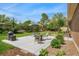 Large backyard patio featuring a dining set, barbecue grill, and lush greenery at 6180 W 77Th Pl, Arvada, CO 80003