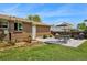 Charming backyard patio featuring a dining set, grill, and garden beds at 6180 W 77Th Pl, Arvada, CO 80003
