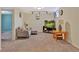 Cozy living area in basement with comfortable seating, a TV, and natural light from the window at 6180 W 77Th Pl, Arvada, CO 80003