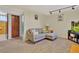 Finished basement area with a comfortable seating area, television and closet with wood doors at 6180 W 77Th Pl, Arvada, CO 80003