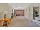 Large basement offers versatile space, featuring plush carpeting, exposed brick accent wall, and ample storage at 6180 W 77Th Pl, Arvada, CO 80003