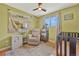 Bedroom with hardwood floors, soft green walls, area rug, and large window and neutral tones at 6180 W 77Th Pl, Arvada, CO 80003