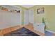 Bedroom featuring hardwood floors, ample closet space, light green walls, and simple decor at 6180 W 77Th Pl, Arvada, CO 80003