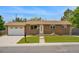 Charming single-story brick home with a manicured lawn, attached garage, and inviting front entrance at 6180 W 77Th Pl, Arvada, CO 80003