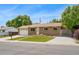 Picture of a one story brick home with an attached garage and a well manicured front lawn at 6180 W 77Th Pl, Arvada, CO 80003