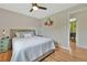 Inviting main bedroom featuring hardwood floors and a ceiling fan, and nice lighting from the window at 6180 W 77Th Pl, Arvada, CO 80003
