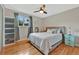 Comfortable main bedroom featuring hardwood floors, ceiling fan, and ample natural light from the window at 6180 W 77Th Pl, Arvada, CO 80003