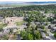 Aerial view showcasing the neighborhood with lake and mountains in the distance on sunny day at 7695 S Harlan St, Littleton, CO 80128
