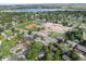 Scenic aerial view shows the neighborhood next to a school, park, and a blue lake at 7695 S Harlan St, Littleton, CO 80128