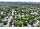 Panoramic aerial view showcases homes nestled among lush trees, with mountains in the distance at 7695 S Harlan St, Littleton, CO 80128