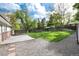 Spacious fenced backyard with lush green lawn and stone accents, perfect for outdoor activities at 7695 S Harlan St, Littleton, CO 80128